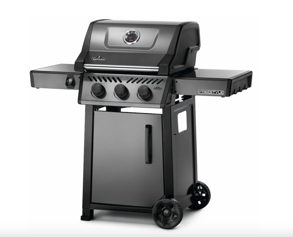 Napoleon Freestyle 365 Propane Gas BBQ in dark grey with three dials and two wheels (Photo via The Home Depot)