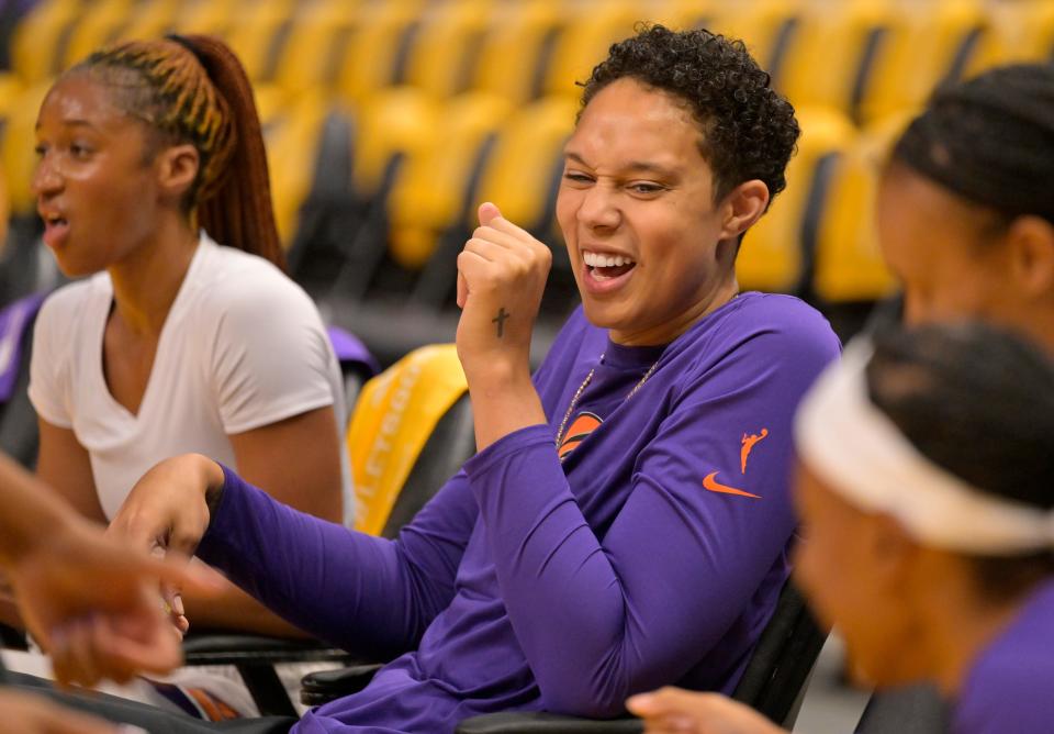 Phoenix Mercury center Brittney Griner laughs as she looks on from the seats as players warm up prior to the game against the Los Angeles Sparks at Crypto.com Arena.