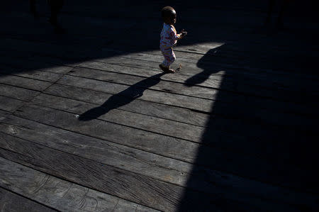 A sick child walks after getting medical treatment at Agats village in Asmat district, after the government dispatched military and medical personnel to the remote region of Papua to combat malnutrition and measles, Indonesia, January 22, 2018. Picture taken January 22, 2018. Antara Foto/M Agung Rajasa/ via REUTERS