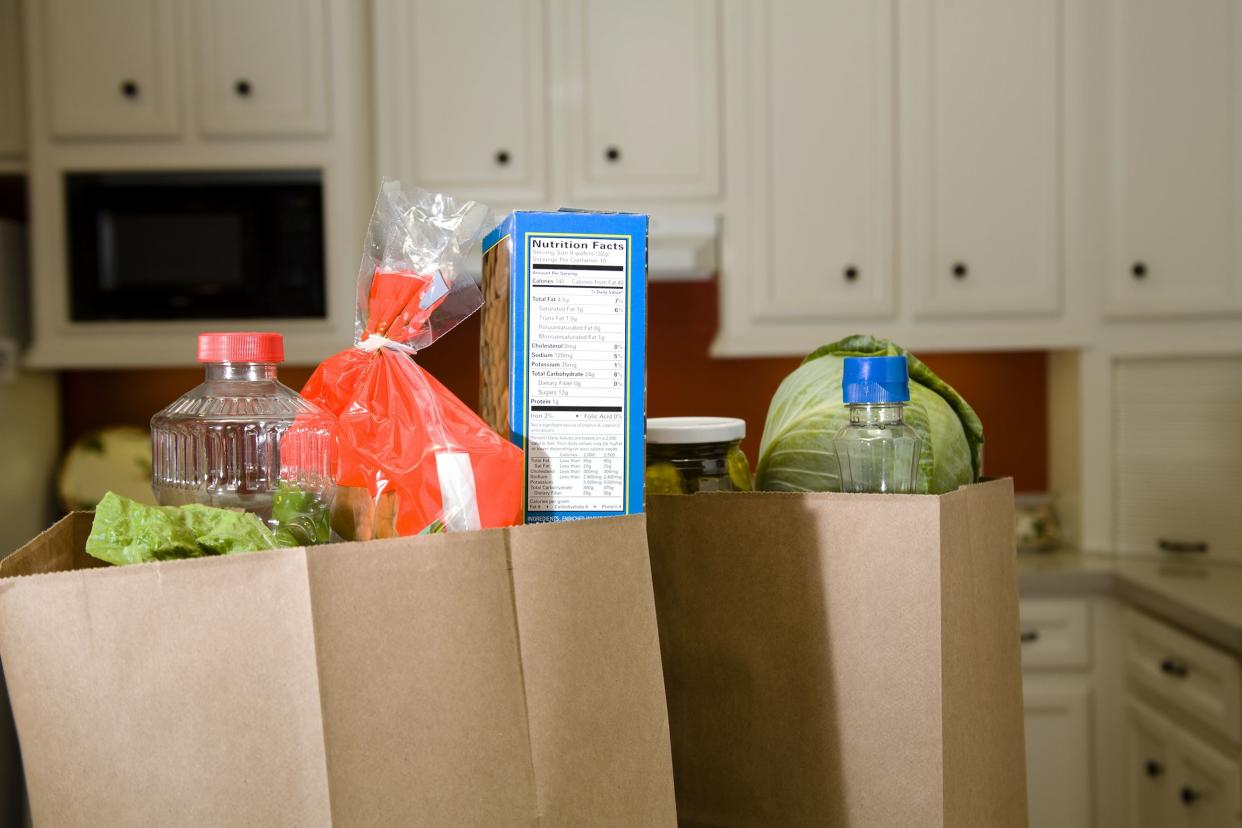 full grocery bags sitting on the kitchen counter