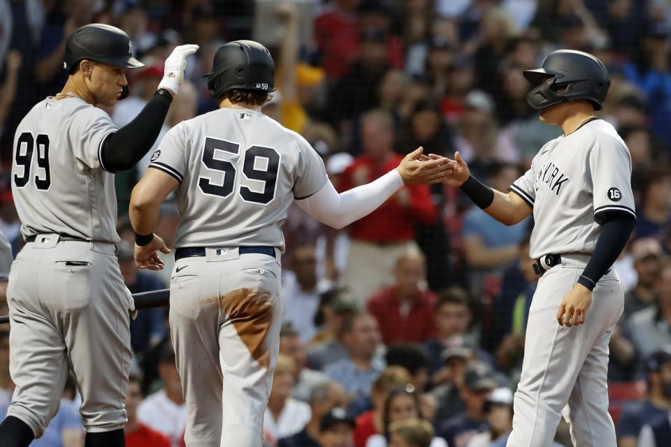 New York Yankees' Gio Urshela, right, celebrates after scoring with Luke Voit (59) on a two-run single by DJ LeMahieu during the second inning of a baseball game against the Boston Red Sox, Friday, June 25, 2021, in Boston. (AP Photo/Michael Dwyer)