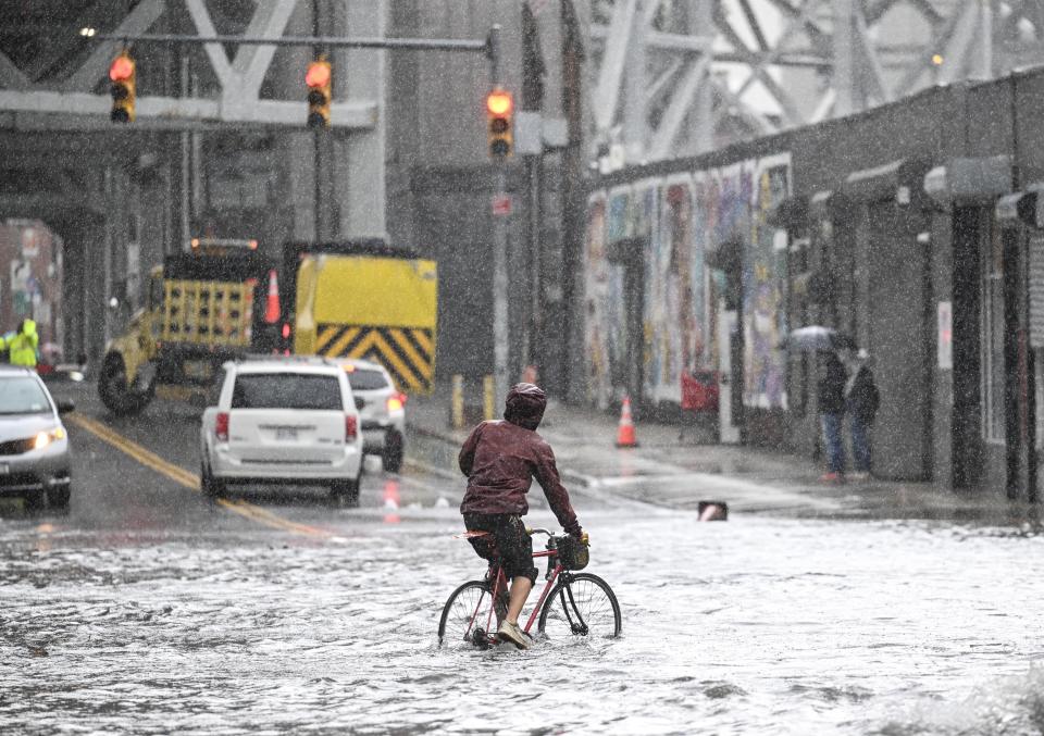 Cars struggle in a flooded street in Brooklyn, New York