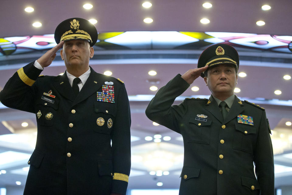 U.S. Army Chief of Staff Gen. Raymond Odierno, left, and Gen. Wang Ning, deputy Chief Staff of the People's Liberation Army (PLA), salute as they review an honor guard at China's Ministry of Defense in Beijing, Friday, Feb. 21, 2014. The U.S. Army chief met with top Chinese generals in Beijing Friday amid regional tensions and efforts to build trust between the two nation's militaries. (AP Photo/Alexander F. Yuan, Pool)