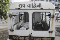 Bodies of victims of a fire lie inside an ambulance in Vijay Vallabh COVID-19 hospital at Virar, near Mumbai, India, Friday, April 23, 2021. A fire killed 13 COVID-19 patients in a hospital in western India early Friday as an extreme surge in coronavirus infections leaves the nation short of medical care and oxygen. (AP Photo)