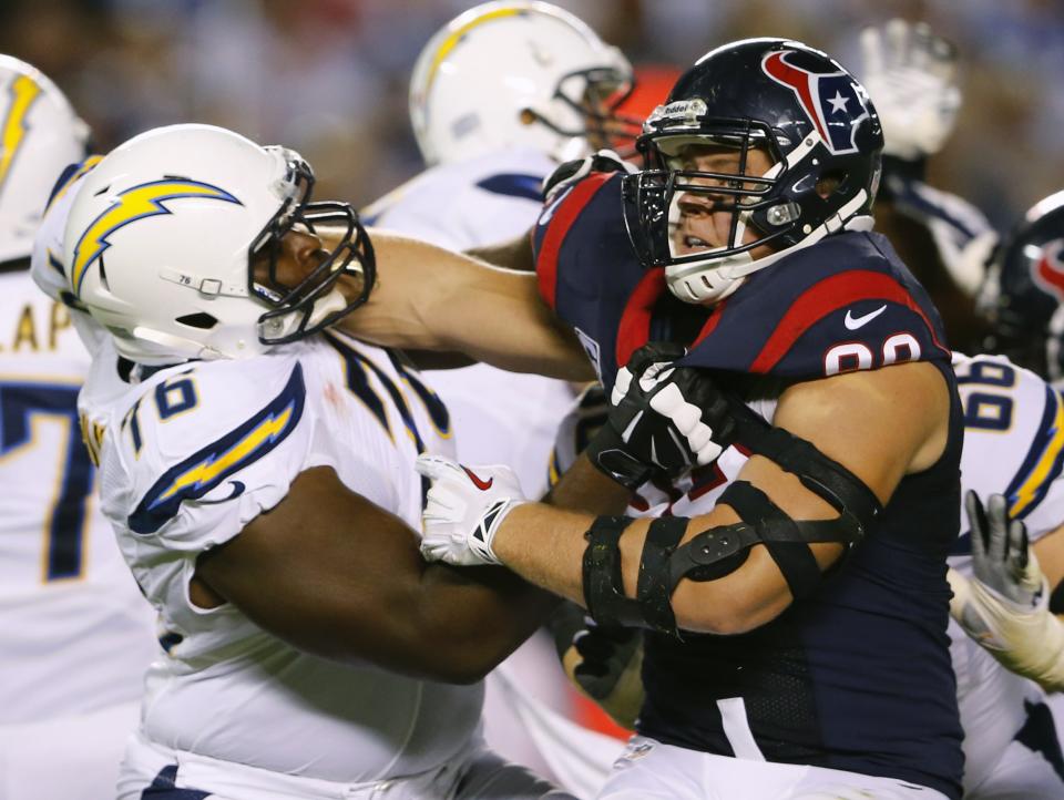 San Diego Chargers offensive tackle D.J. Fluker and Houston Texans defensive end J.J. Watt battle along the line in the first half during their Monday Night NFL football game in San Diego