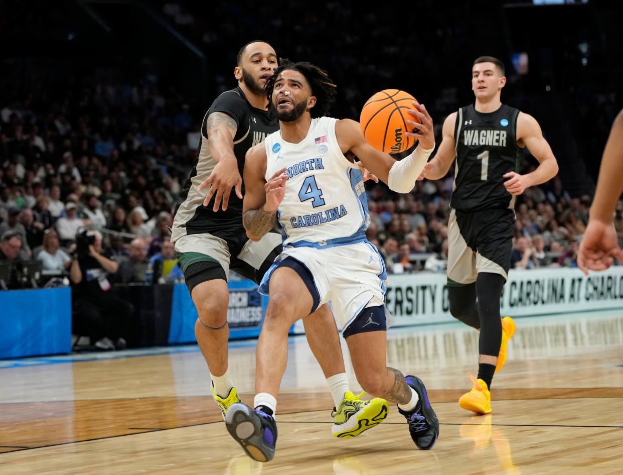 North Carolina guard RJ Davis (4) drives to the basket against Wagner in the first round of the 2024 NCAA men's tournament at the Spectrum Center.
