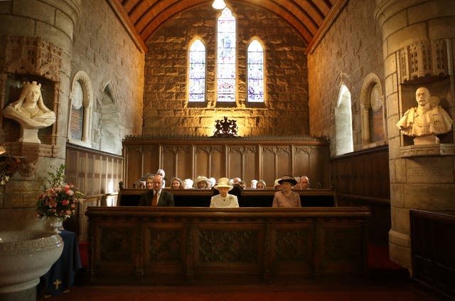 Queen Elizabeth II sits in Crathie Kirk during a service in 2014