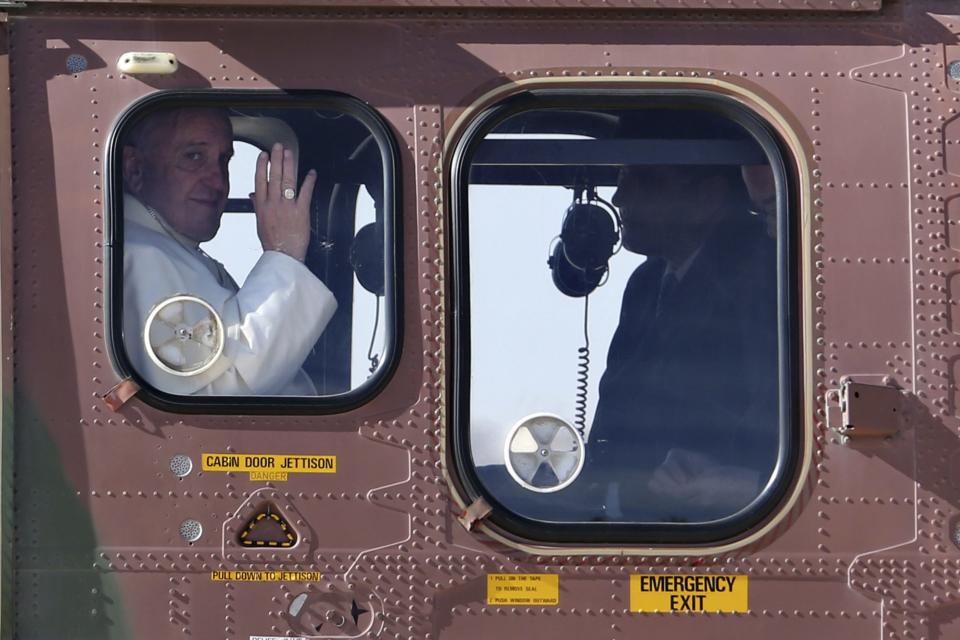 Pope Francis waves as he leaves for the West Bank after his visit to Jordan, at Queen Alia International Airport in Amman