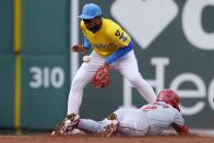Los Angeles Angels' Luis Rengifo (2) steals second base as Boston Red Sox's Pablo Reyes, top, gets the throw during the third inning of a baseball game, Sunday, April 14, 2024, in Boston. (AP Photo/Michael Dwyer)