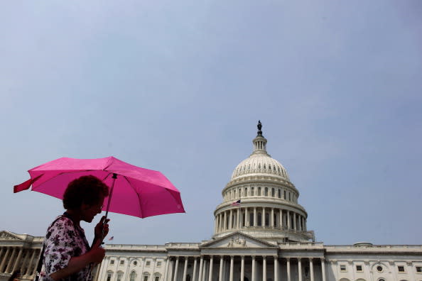 As temperatures top 100-degrees in the nation's capital, visitors take their shade with them by carrying umbrellas as they tour the U.S. Capitol grounds June 29, 2012 in Washington, DC. Heat warnings are up and people are being told to stay indoors as the heat index will soar to around 110-degrees Friday and Saturday. (Photo by Chip Somodevilla/Getty Images)