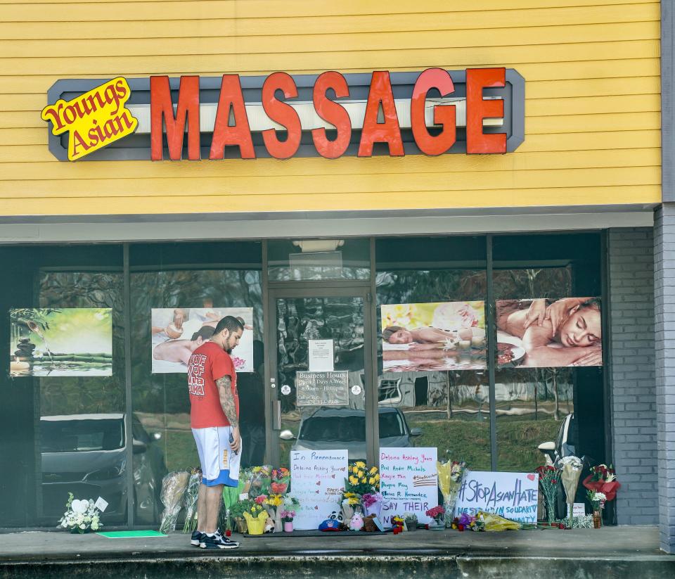 Visitors have left flowers at Young's Asian Massage in Acworth, Georgia, a site of Tuesday night's shooting.