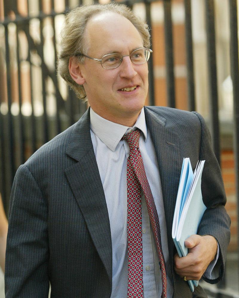 Man holding a bundle of papers