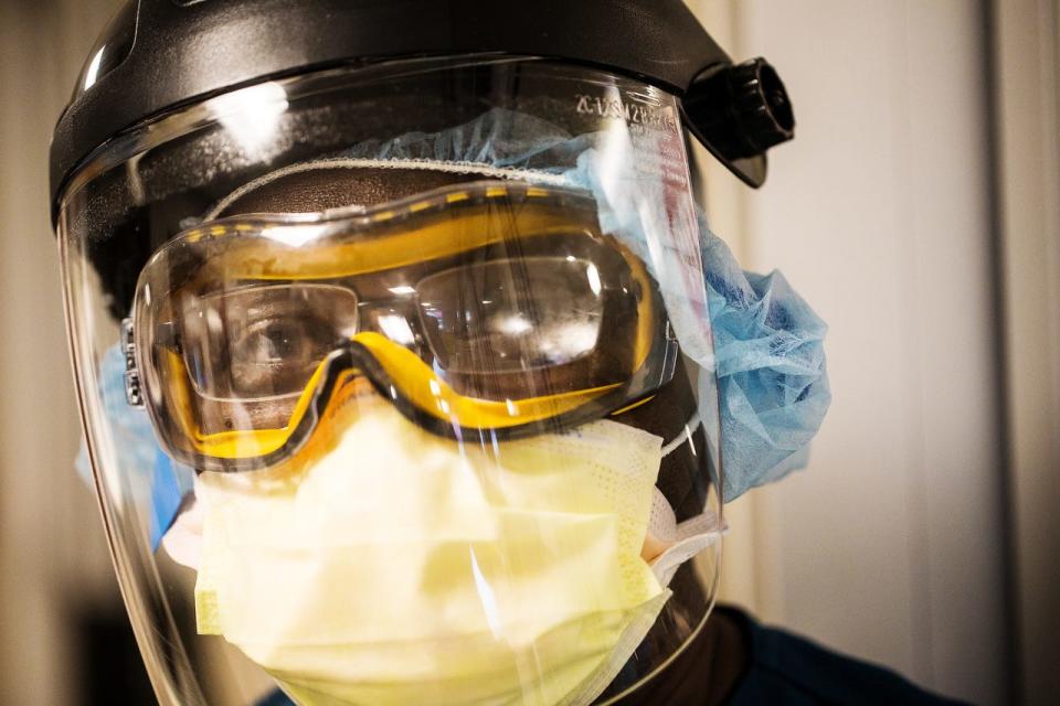 Evens Saint-Louis, a respiratory therapist at the downtown campus of NCH in Naples pauses for a portrait between patients in the Intensive Care Unit on Monday, August 9, 2021. He was treating a COVID-19 patient before this photo was taken. 