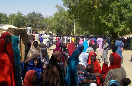 People gather after the release of scores of Nigerian schoolgirls by Islamist militants in Dapchi, in the northeastern state of Yobe, Nigeria March 21, 2018. REUTERS/Ola Lanre