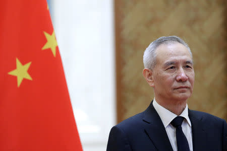 FILE PHOTO: Chinese Vice Premier Liu He waits to shake hands with European Commission Vice President Jyrki Katainen ahead of the EU-China High-level Economic Dialogue at Diaoyutai State Guesthouse in Beijing, China, June 25, 2018. REUTERS/Jason Lee/File Photo