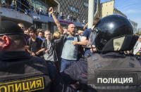 <p>Protesters shout anti-government slogans behind a police line at a demonstration against President Vladimir Putin in Pushkin Square in Moscow, Russia, Saturday, May 5, 2018. A group that monitors political repression in Russia says more than 350 people have been arrested in a day of nationwide protests against the upcoming inauguration of Vladimir Putin for a new six-year term as president. (Photo: Dmitry Serebryakov/AP) </p>