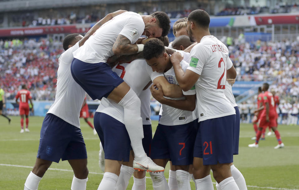 <p>England players run to teammate John Stones after he scored his team’s first goal </p>