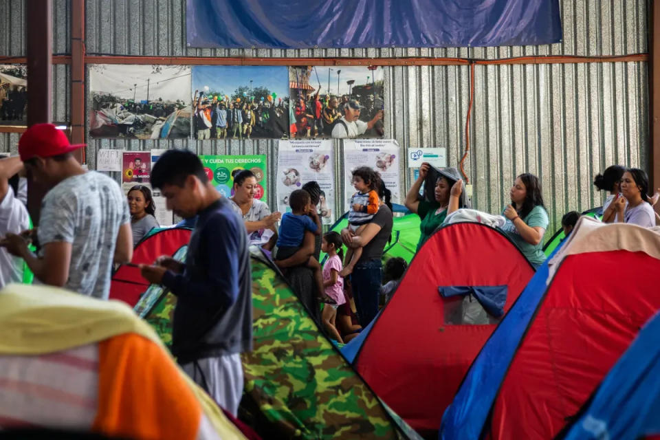 Migrants wait in line to receive toiletry items at Moviemiento Juventud 2000 in Tijuana, Mexico on July 26, 2023.