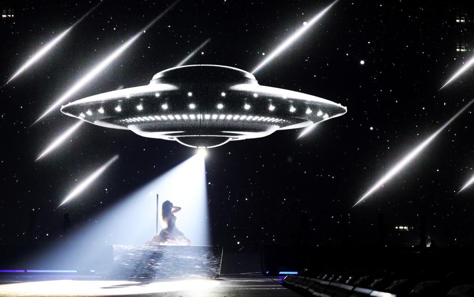 “For a minute I knew cosmic love,” Swift sings beneath the beam of a UFO.