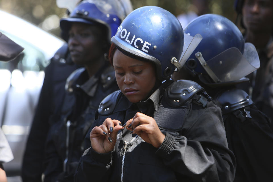 Armed riot police block doctors as they protest in Harare, Wednesday, Sept, 18, 2019. Zimbabwean doctors protesting the alleged abduction of a union leader were met by a line of baton- wielding police in the capital as fears grow about government repression. (AP Photo/Tsvangirayi Mukwazhi)