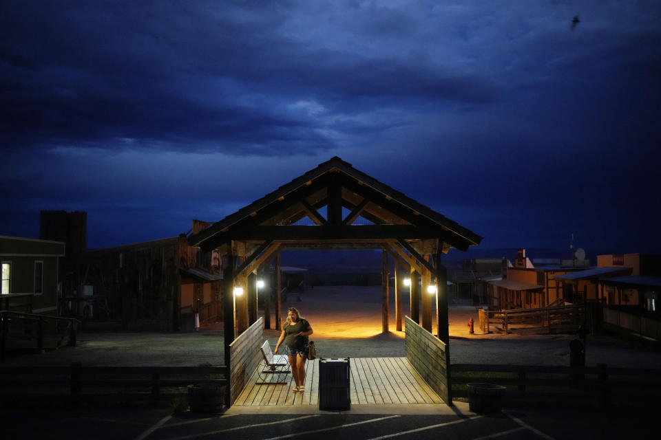 A person walks through an entranceway to the Hualapai Ranch on the Hualapai reservation Monday, Aug. 15, 2022, in northwestern Arizona. Despite the Colorado River coursing more than 100 miles through Hualapai land, the tribe can't draw from it. (AP Photo/John Locher)