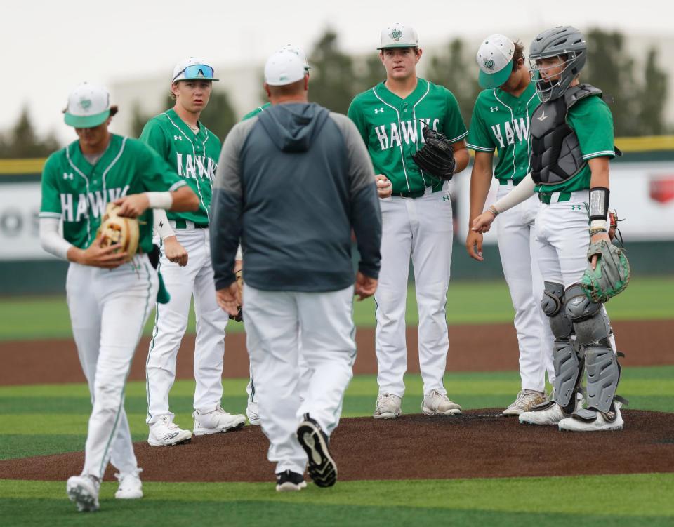 Wall head coach Jason Schniers meets with his infield and pitcher in the sixth inning in the third game of a best-of-three Region I-3A semifinal series against Bushland on Saturday, May 27, 2023, at Lubbock-Cooper’s Pirate Field at First United Park.