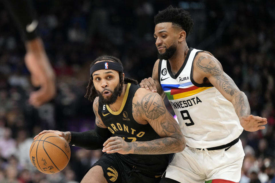 Minnesota Timberwolves guard Nickeil Alexander-Walker (9) defends Toronto Raptors guard Gary Trent Jr. (33) during the first half of an NBA basketball game, in Toronto, Saturday, March 18, 2023. (Frank Gunn/The Canadian Press via AP)