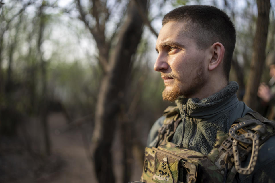 A Ukrainian serviceman from Azov brigade known by call sign Ray, 20, stands on his position on the frontline in Kreminna direction, Donetsk region, Ukraine, Thursday, April 11, 2024. (AP Photo/Alex Babenko)