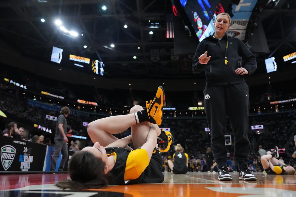 Iowa Hawkeyes guard Caitlin Clark stretches during Saturday's Women's Final Four open practice at Rocket Mortgage FieldHouse.