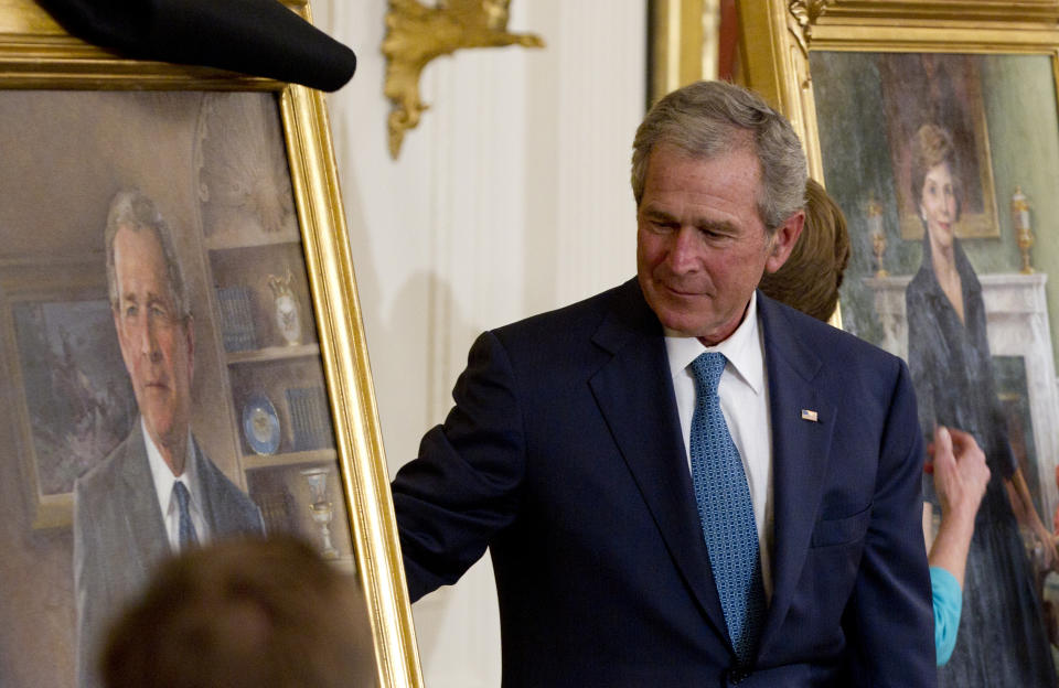 FILE - Former President George W. Bush and former first lady Laura Bush, right, unveil their portraits in the East Room of the White House in Washington, May 31, 2012. (AP Photo/Carolyn Kaster, File)