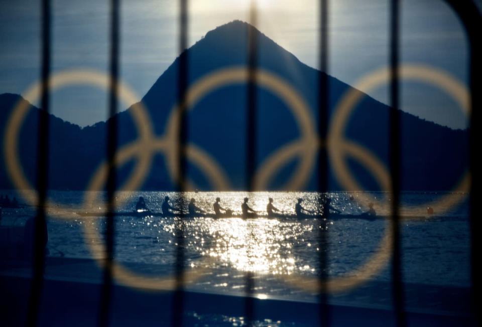 Rowers are seen through a decorated screen