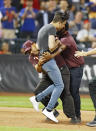 Stadium security officers tackle an unruly fan who ran onto the field interrupting an MLB baseball game between the Philadelphia Phillies and New York Mets on July 11, 2018 at Citi Field in the Queens borough of New York City. Mets won 3-0. (Photo by Paul Bereswill/Getty Images)