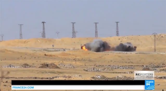 The suicide car was turned into a smoking fireball. Source: France 24