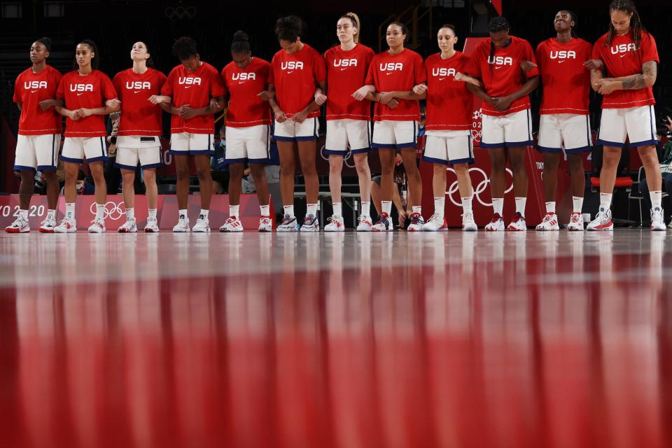 Team USA stands arms interlocked as the national anthem plays ahead of their semifinal game against Serbia.