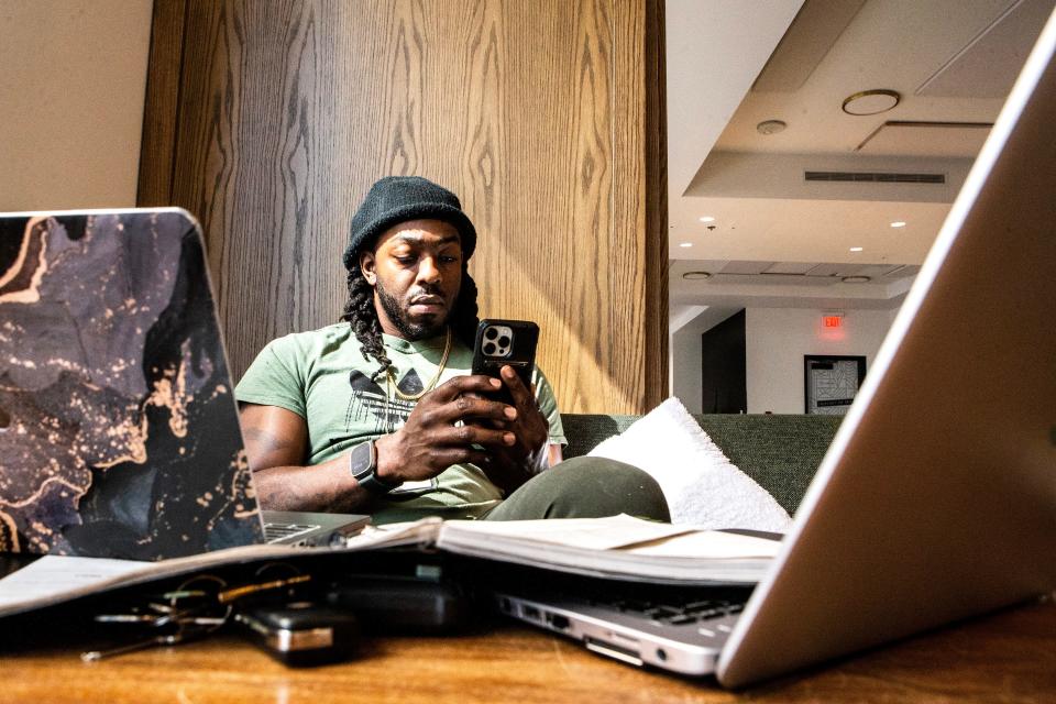 A patron works in the lounge area of DE.CO, a food hall located in the DuPont Building in downtown Wilmington on Thursday, March 16, 2023.