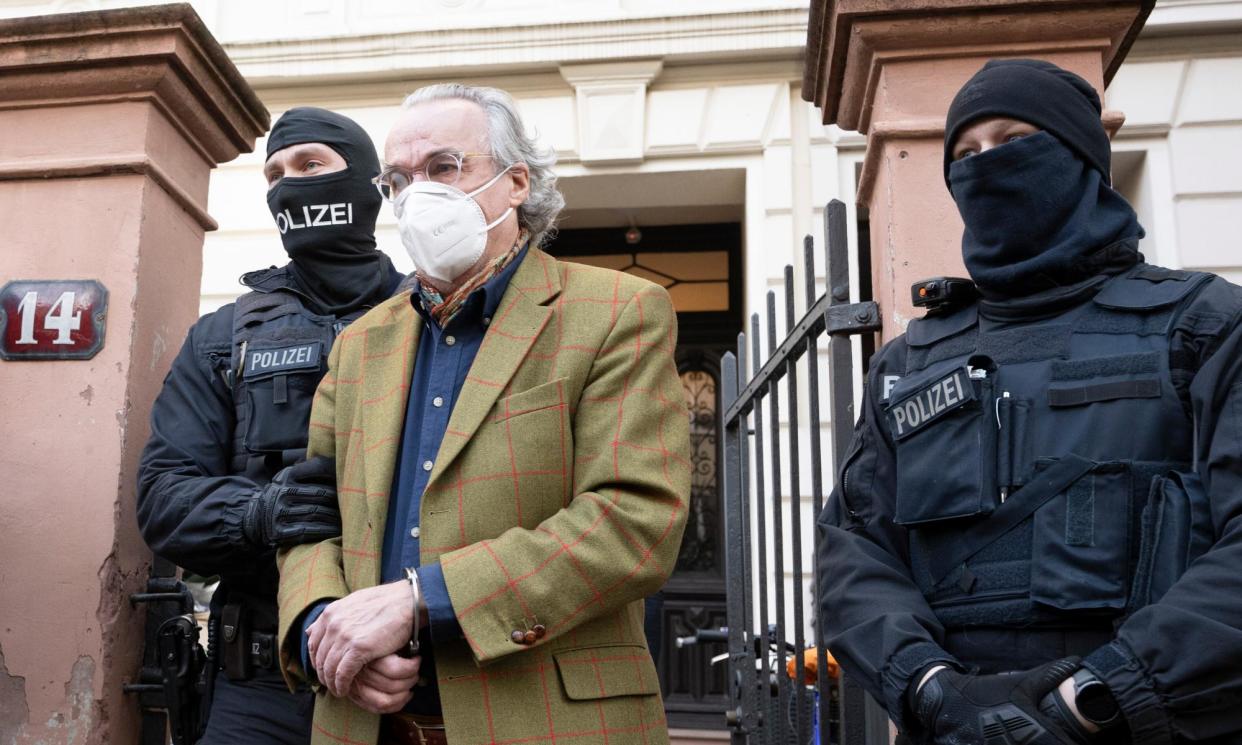 <span>Heinrich XIII Prince Reuss is led away after dawn raids by police in December 2022.</span><span>Photograph: Boris Roessler/AP</span>