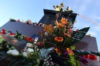 Candles and flowers are seen placed around the Brothers Grimm monument for the victims of a shooting in Hanau