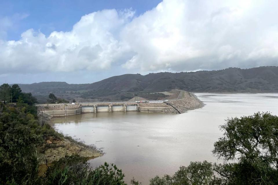 Lake Cachuma is expected to fill and spill over Bradbury Dam, above, by this weekend, according to county officials. The lake level has come up 34 feet in about a day.