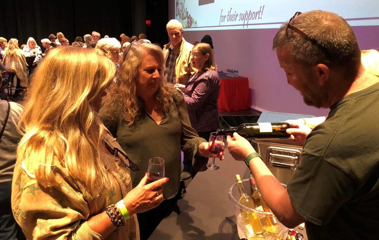 Steve Clayton, Three Leg Run Brewery Winery and Meadery owner, pours wine at the Kiwanis Club of Chester Wine Tasting Festival at the Perkinson Center for the Arts and Education in Chester on March 18, 2023.