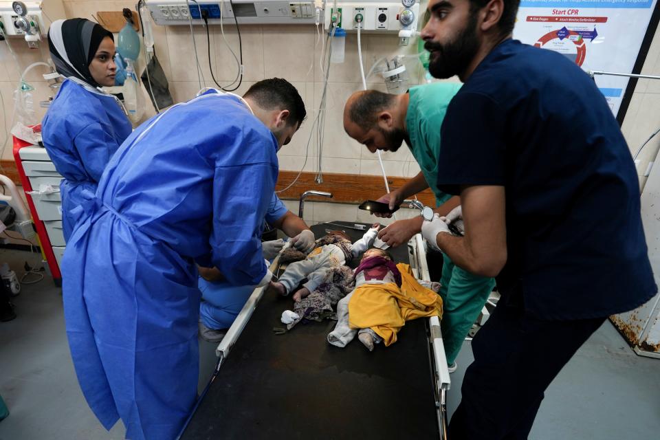 Medics treat children wounded in the Israeli bombardment of the Gaza Strip in a hospital in Deir Al-Balah (Copyright 2023 The Associated Press. All rights reserved.)