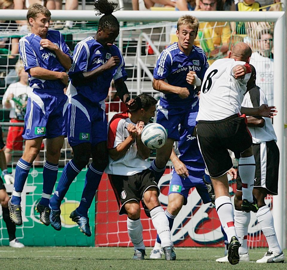 (NCL MLSSTAR LAURON MERZ 30JUL05) Major League Soccer All Stars Ronnie O'Brien, 6, Shalrie Joseph, 8, and Taylor Twellman, 3, go up to block a free kick by Claus Jensen during the first half of the MLS All Star game at the Columbus Crew Stadium, July 29, 2005. (Dispatch photo by Neal C. Lauron)