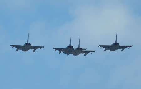 Four Eurofighter jets take part in a flypast as part of celebrations to mark Spain's National Day in Madrid, Spain October 12, 2017. REUTERS/Andrew Winning