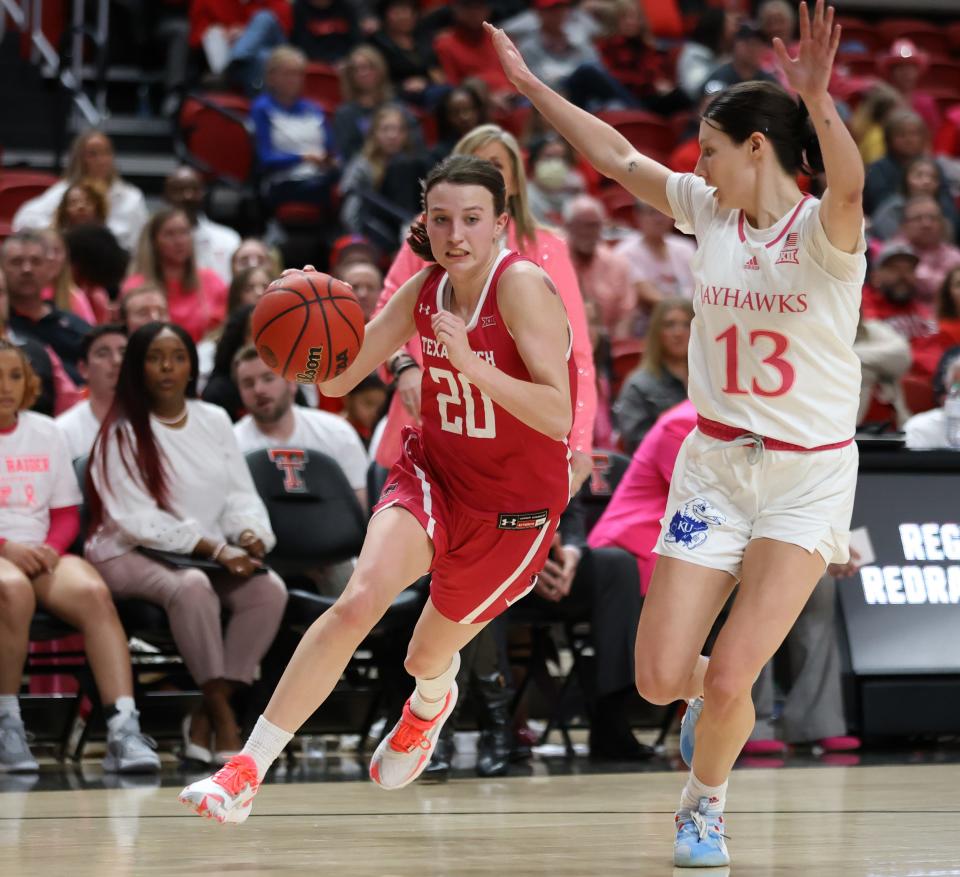 Texas Tech's Bailey Maupin (20) dribbles against Kansas defense in a Big 12 women’s basketball game, Saturday, Feb. 11, 2023, at United Supermarkets Arena.