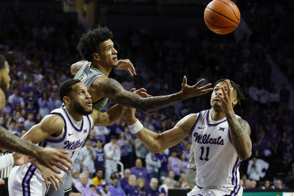 Baylor's forward Jalen Bridges, top, Kansas State guard Markquis Nowell (1) and Kansas State forward Keyontae Johnson (11) go after a loose ball during the first half of an NCAA college basketball game, Tuesday, Feb. 21, 2023, in Manhattan, Kan. (AP Photo/Colin E. Braley)