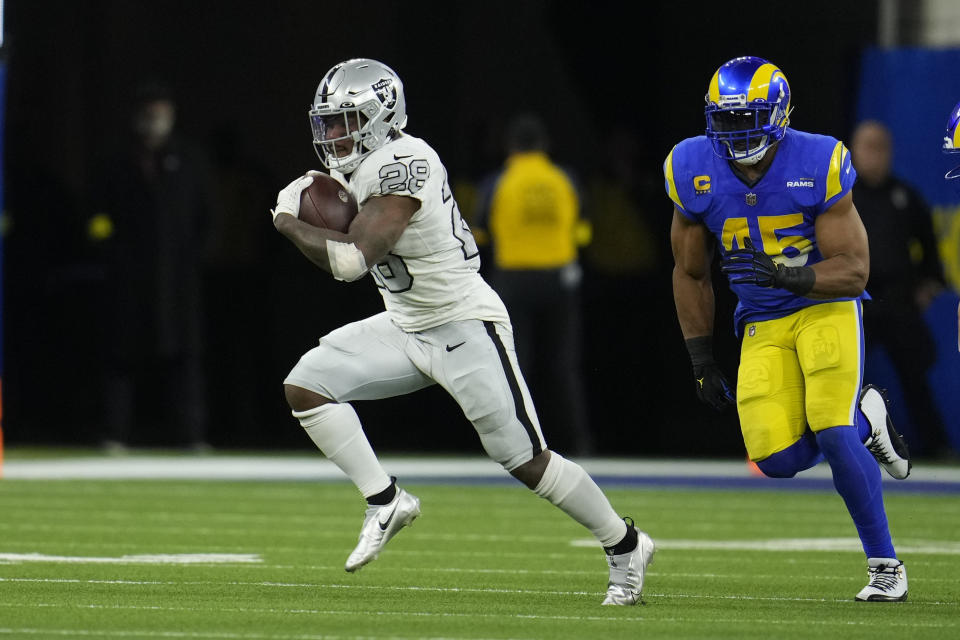 Las Vegas Raiders running back Josh Jacobs runs with the ball during the second half of an NFL football game against the Los Angeles Rams Thursday, Dec. 8, 2022, in Inglewood, Calif. (AP Photo/Marcio Jose Sanchez)