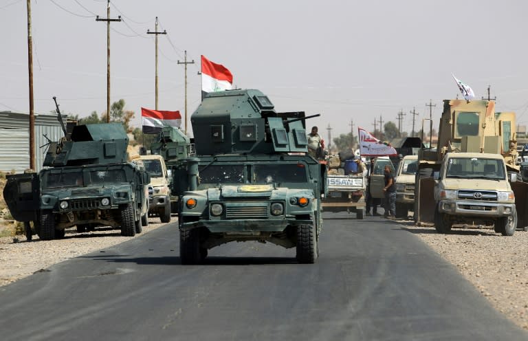 Iraqi forces ride on humvees in the northern Iraqi town of Sharqat on September 22, 2017 as part of a major offensive to oust jihadists from their last Iraq bastions