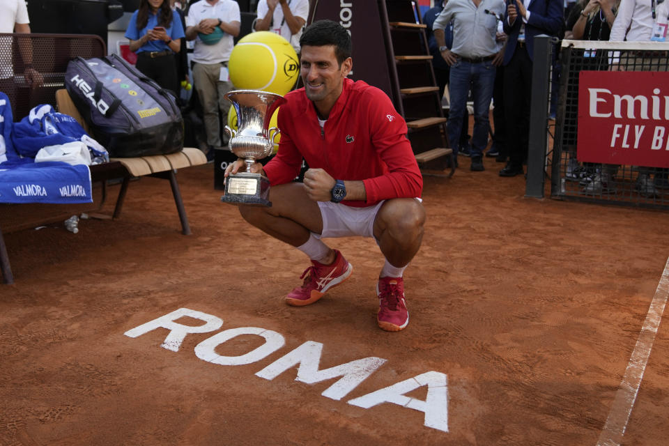 Serbia's Novak Djokovic poses for photographers with trophy after winning his final match against Greece's Stefanos Tsitsipas at the Italian Open tennis tournament, in Rome, Sunday, May 15, 2022. (AP Photo/Alessandra Tarantino)