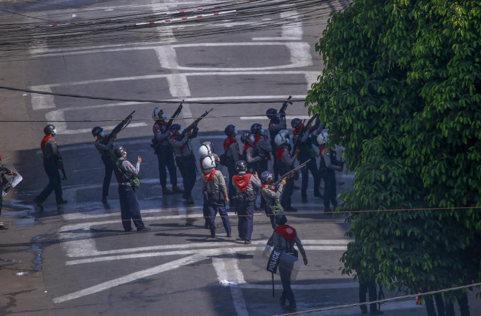 Police officers aim their guns towards people in nearby apartments as they stand off with anti-coup protesters in Yangon, Myanmar, Thursday, March 4, 2021. Demonstrators in Myanmar protesting last month's military coup returned to the streets Thursday, undaunted by the killing of at least 38 people the previous day by security forces. (AP Photo)