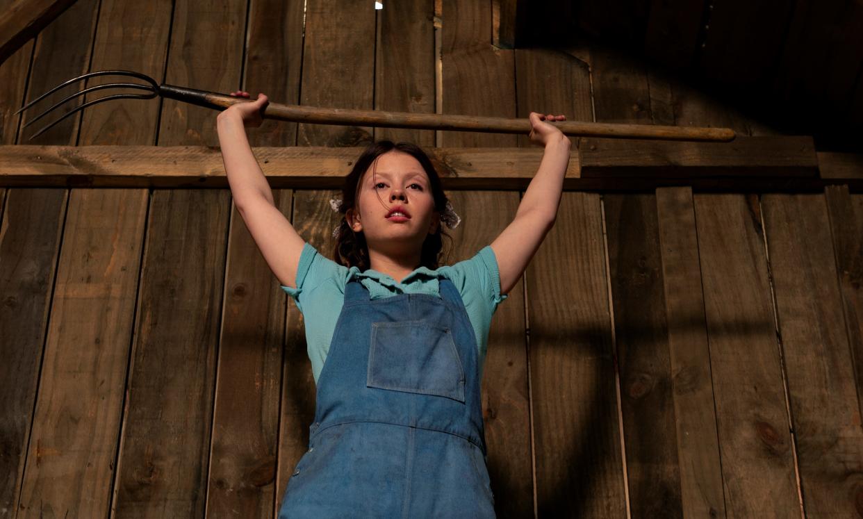 In 1918, a young woman (Mia Goth) has big dreams of a glamorous life far away from her farm in the "X" horror prequel "Pearl."