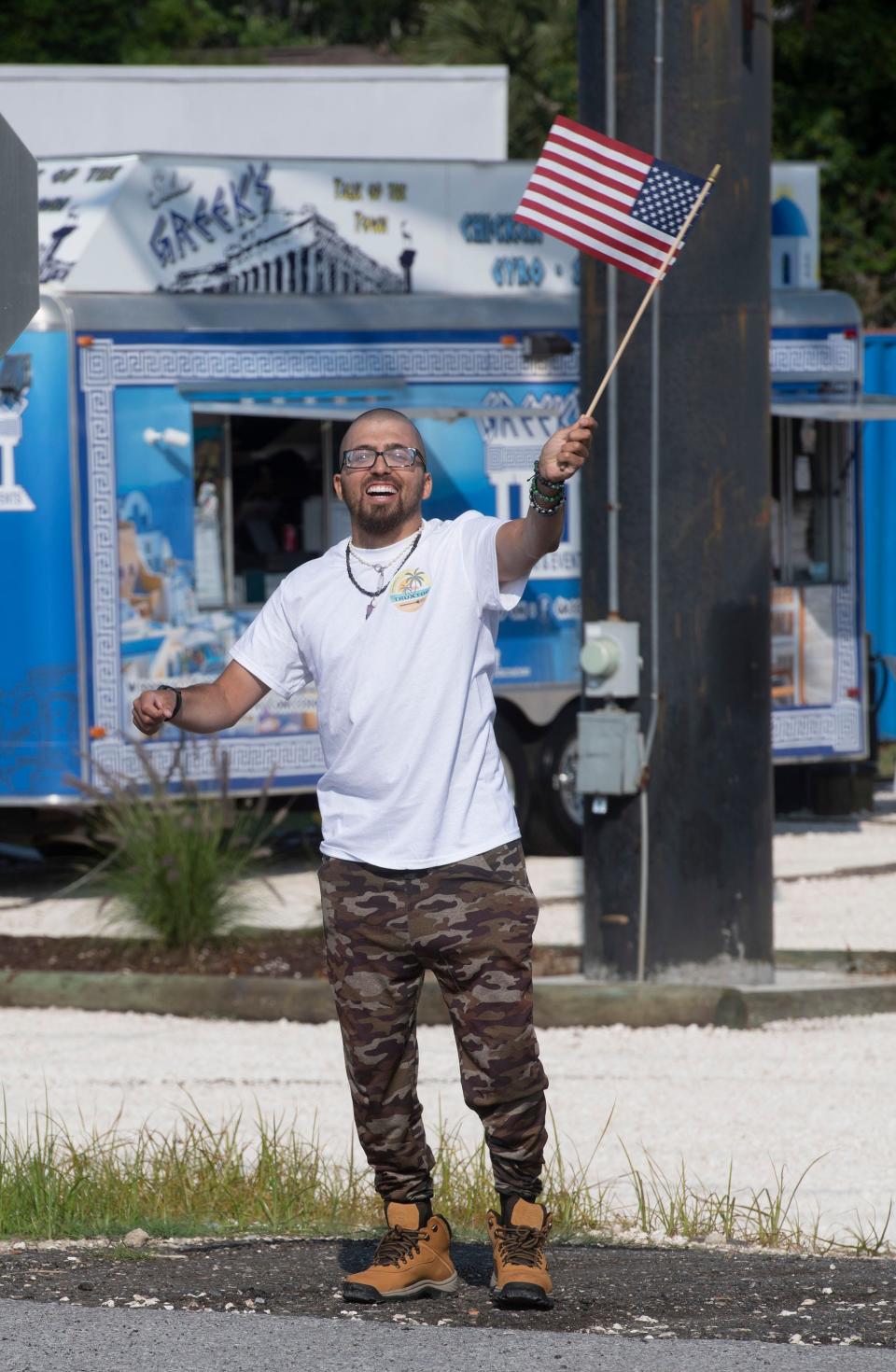 Alex Camero works to drum up customers on the open day of the new Truxtop Food Court in Gulf Breeze on Thursday, May 26, 2023. The new food truck dining spot is on Highway 98, just past the Naval Live Oaks reservation. 